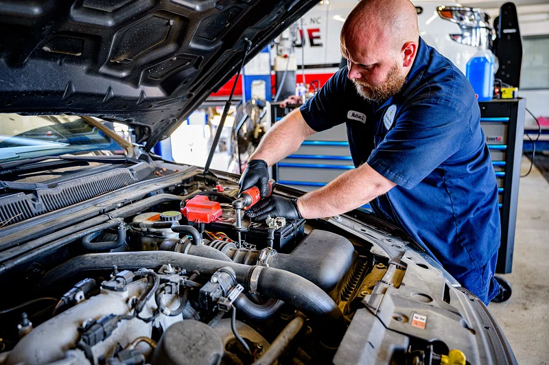MOT checklist UK mechanic checking car tyres"
