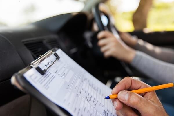 Driving test vehicle checks list showing L-plates